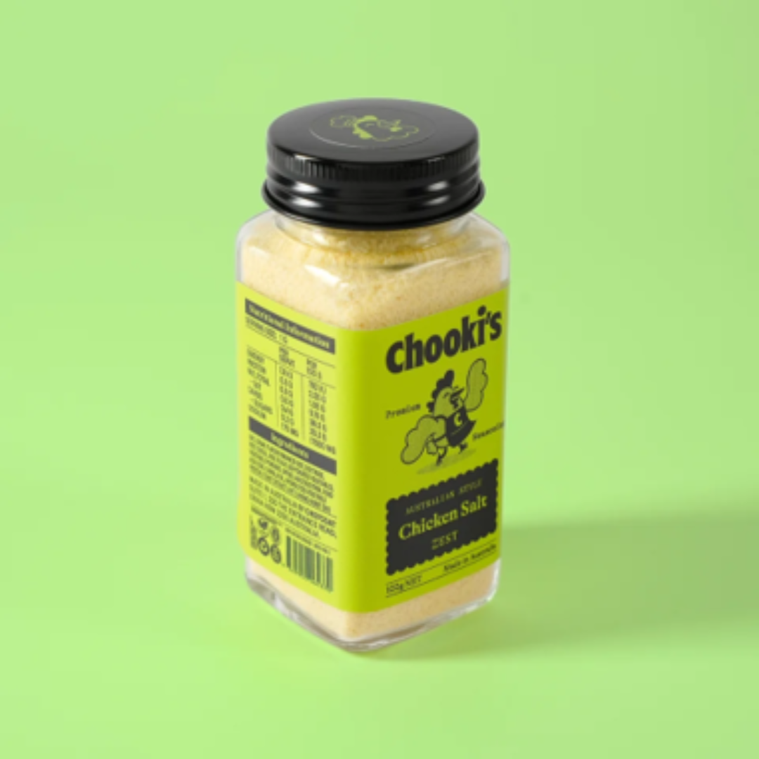A bottle of Chook's Chicken Salt 250g on a solid light green background. The product is in a clear plastic bottle showing the salt inside, topped with a black lid and featuring a bright yellow-green label with black text and graphics.